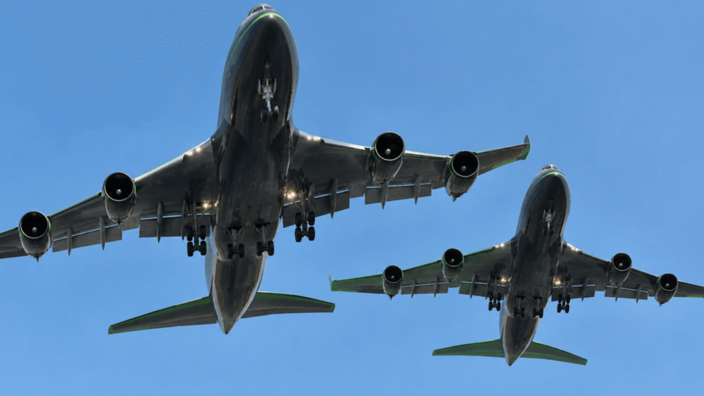 two black as charcoal planes flying very low